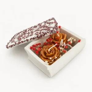 Candles shaped as caramel roses in a white floral gift box