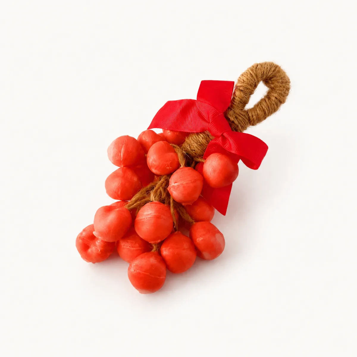 Bougie en forme de grappe de baies rouges avec nœud en satin